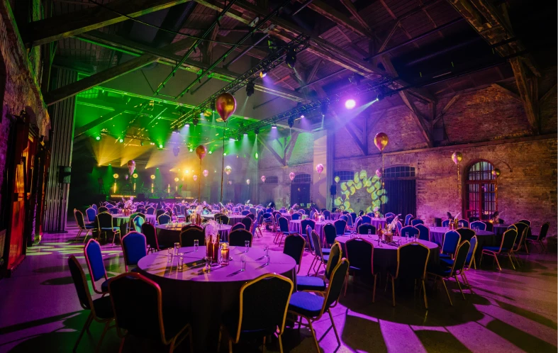 Event venue with round tables and chairs.