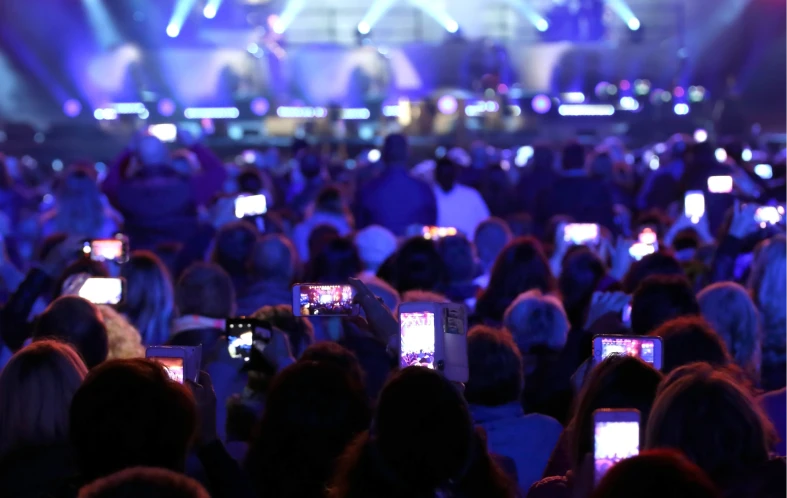 Fans filming concert with smartphones