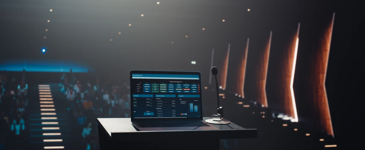 Conference setup with laptop and microphone.