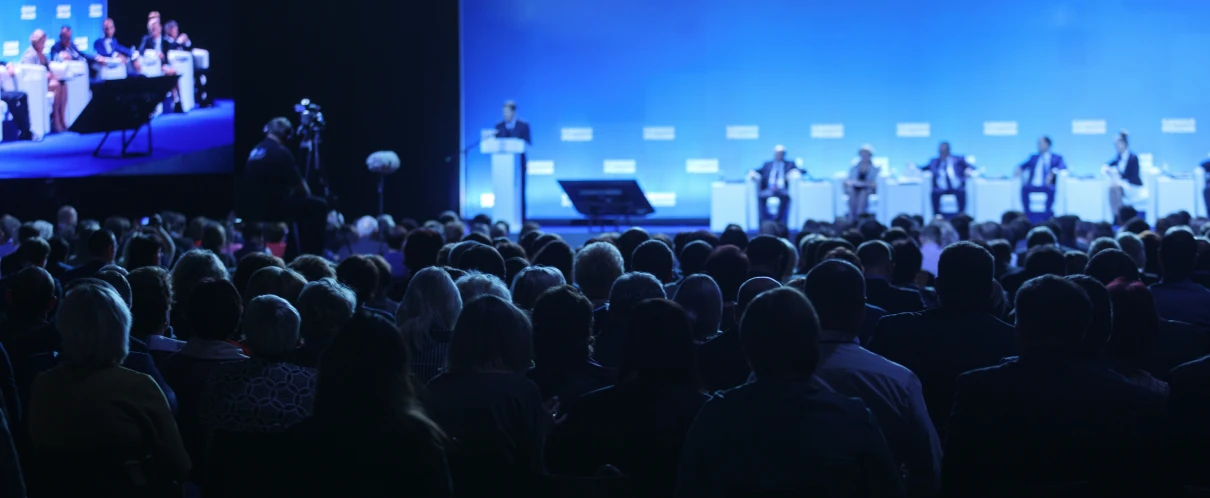 Large crowd attending a panel event